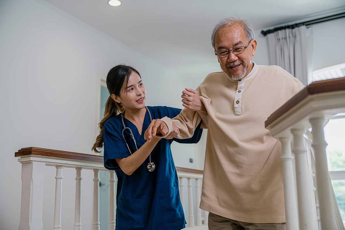 Nurse providing safety supervision while helping a senior on stairs